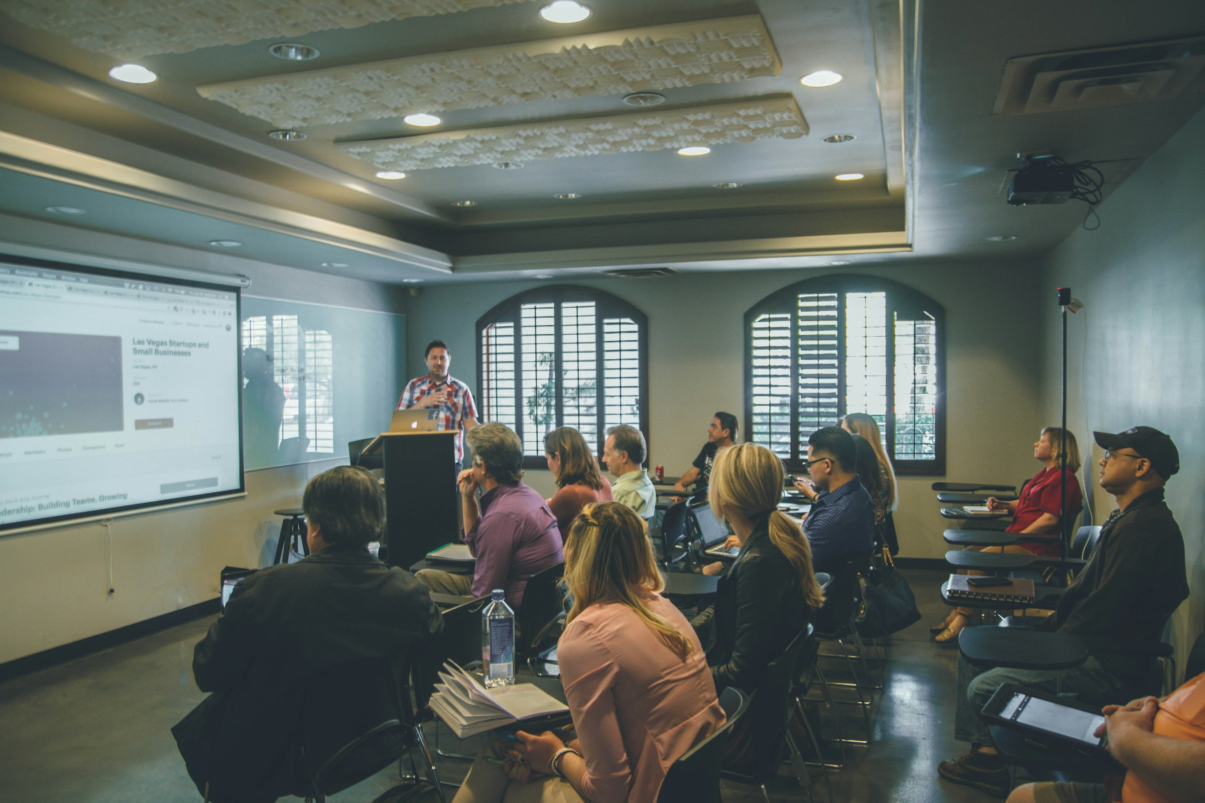 Presenter leading a professional development session for seated staff