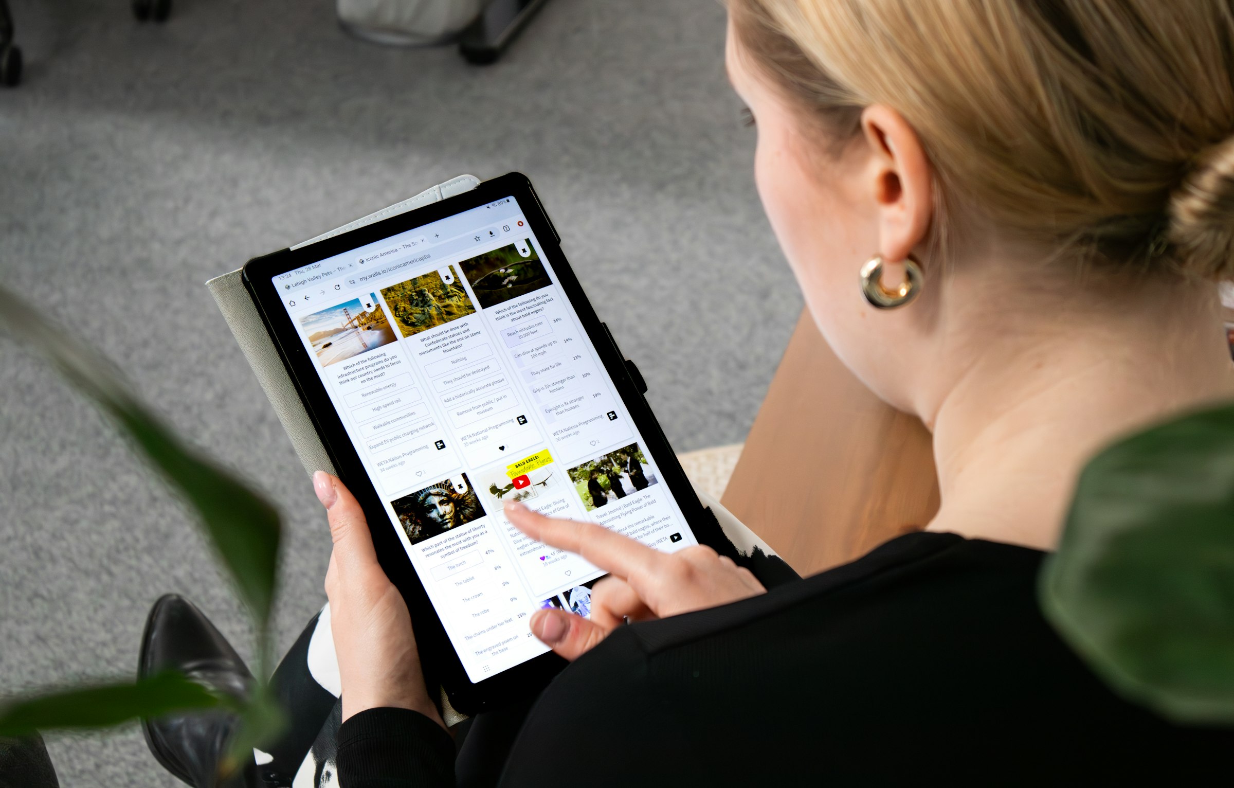 A person completing an online survey on a tablet